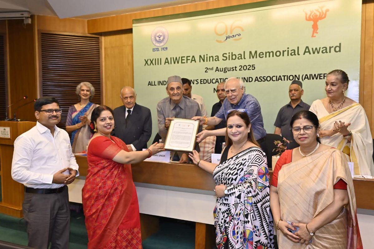 Dr. Alok receiving an award on stage