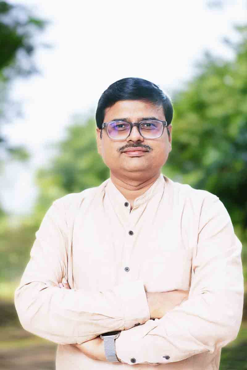 Dr. Alok Kumar Bhuwan, smiling, in formal attire